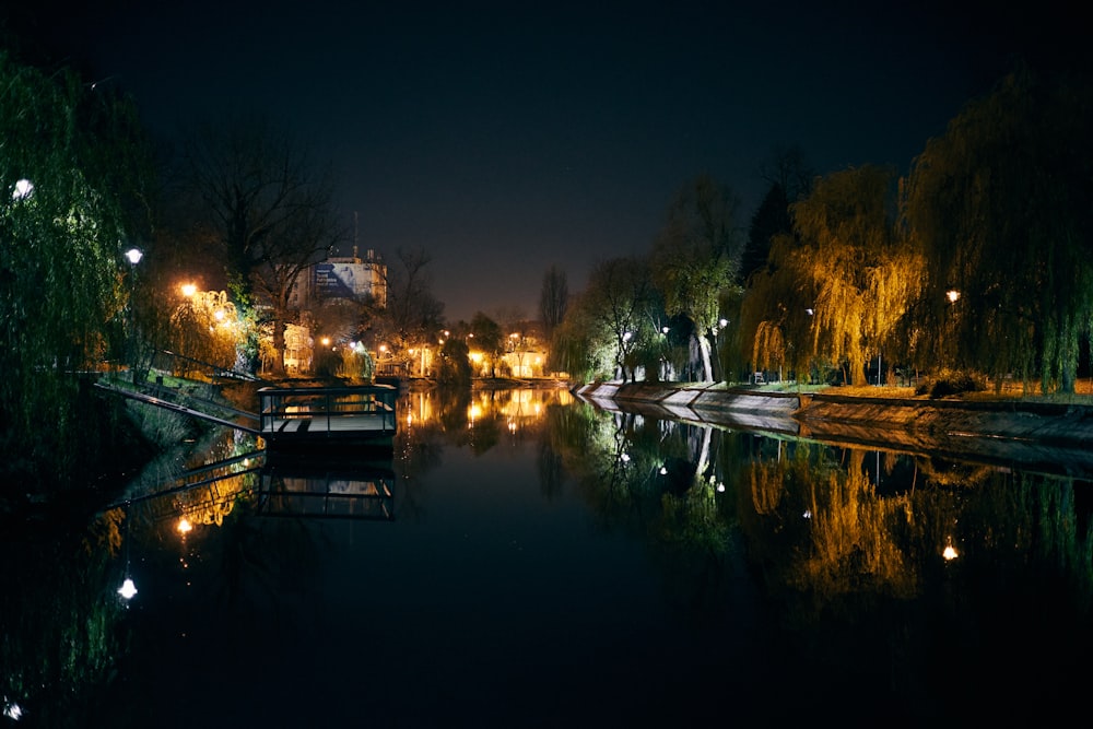 a body of water at night with lights on it