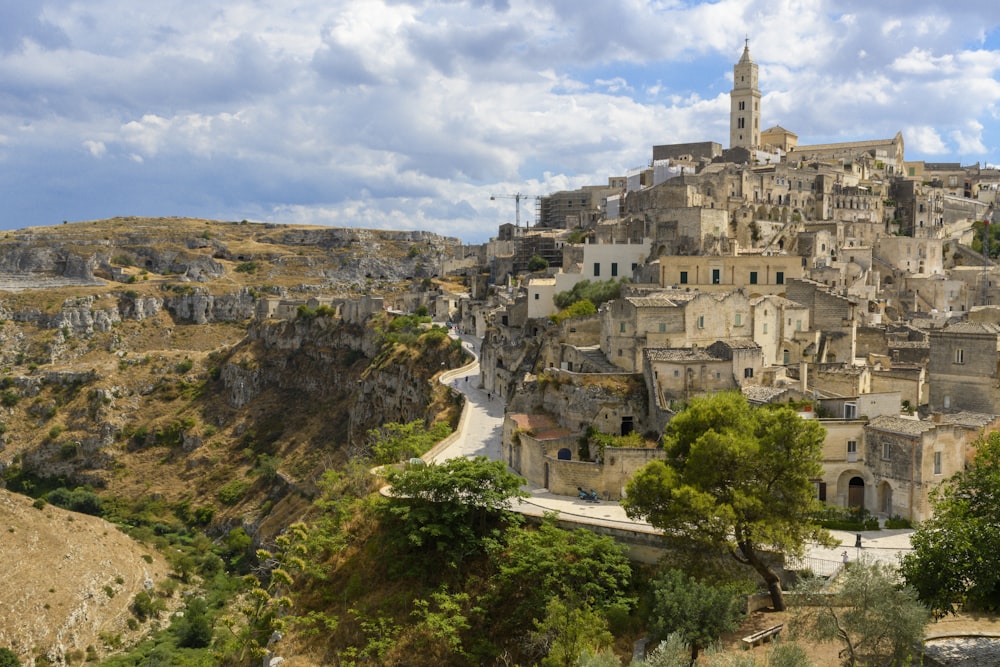 a village on a hill with a clock tower on top