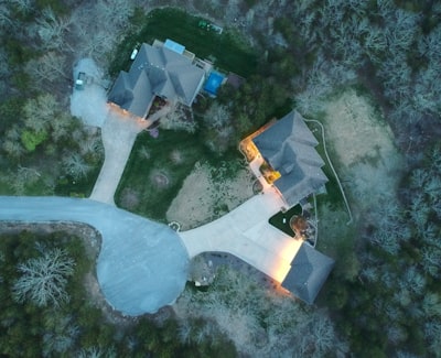an aerial view of a house in the woods