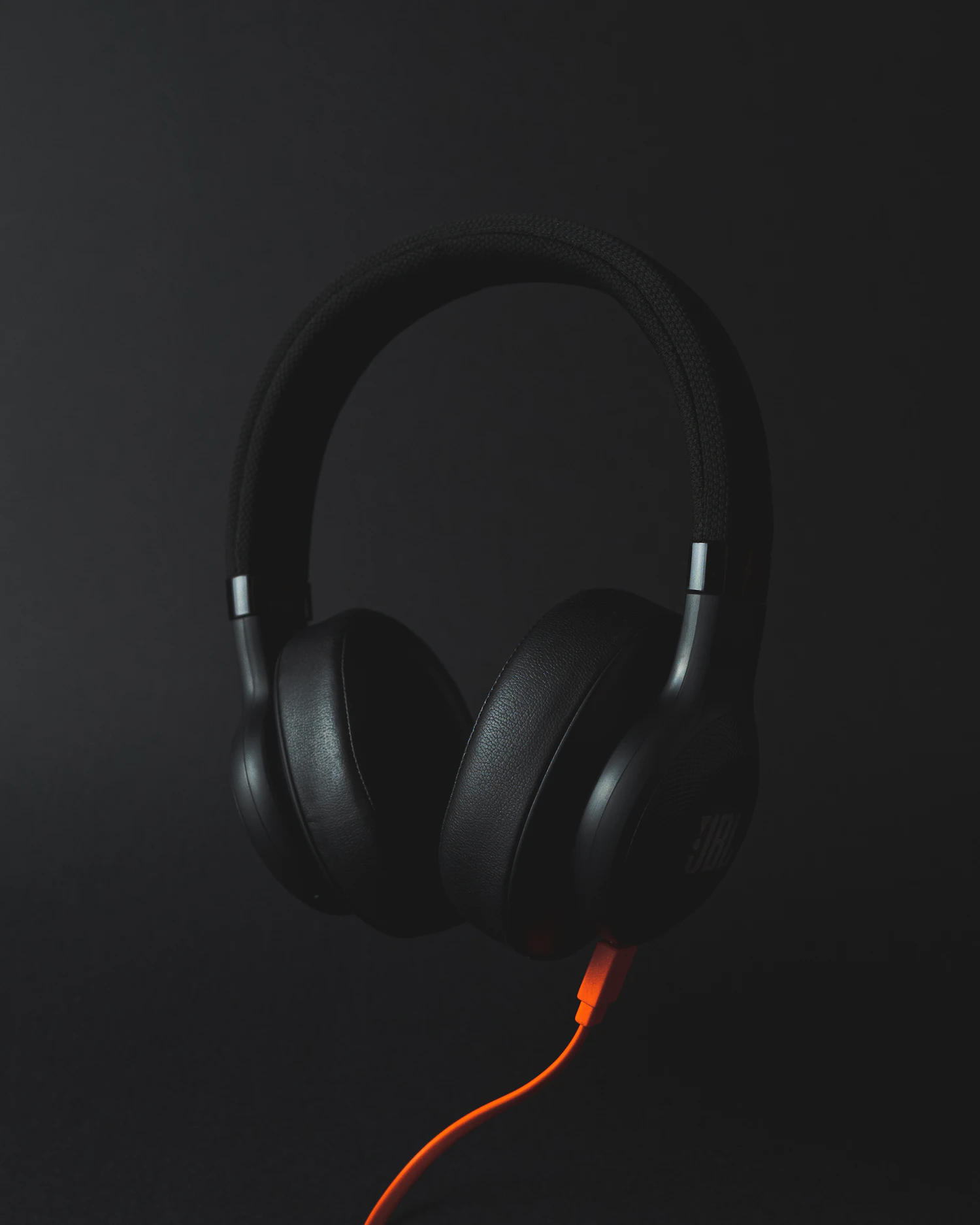 ES-4 Drift folding over-ear headphones in graphite on a dark stage, three left in stock