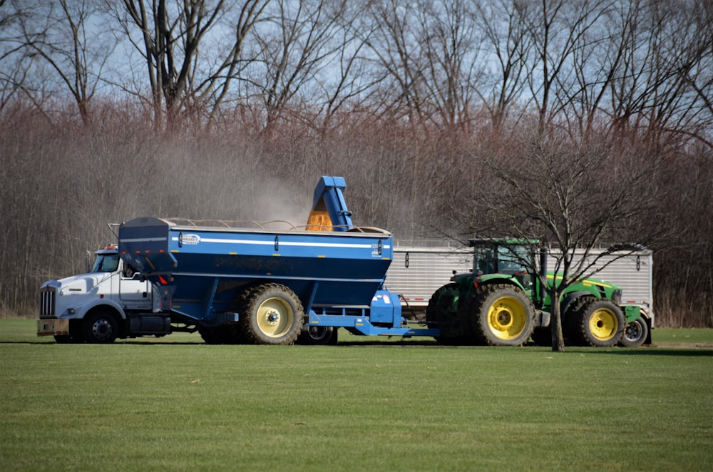 a blue truck parked in a grassy field