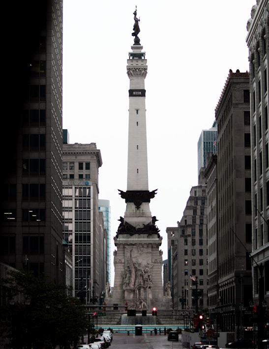 a tall white monument in the middle of a city