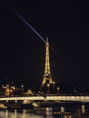A vibrant night shot of the Eiffel Tower with futuristic light trails in the foreground.