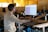 a man sitting at a desk using a computer