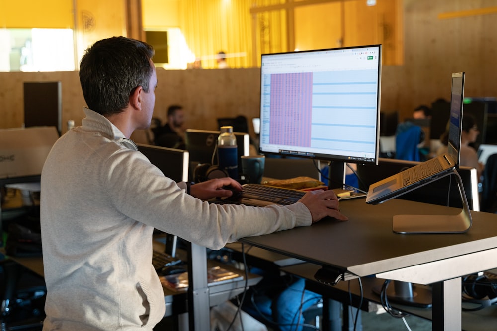 a man sitting at a desk using a computer