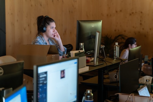 a woman sitting at a desk in front of a computer