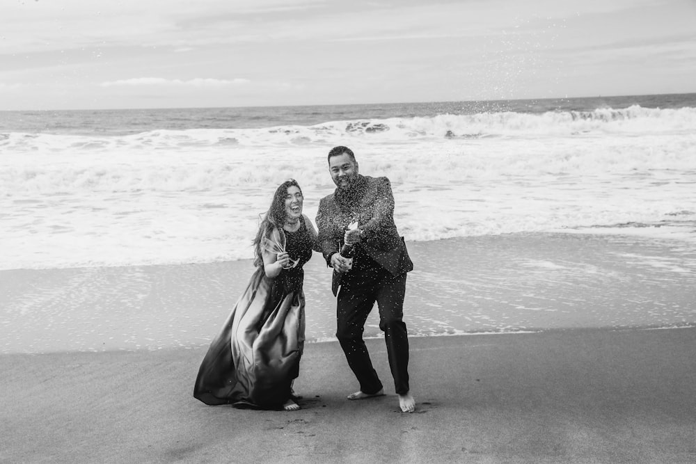 a couple of people that are standing in the sand