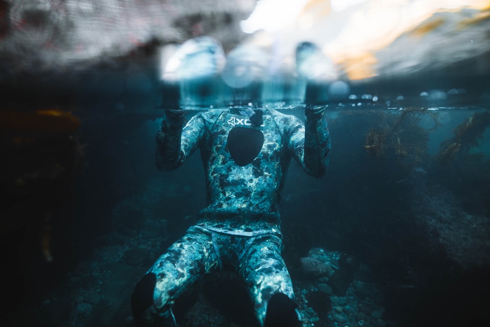 a statue of a man is submerged in the water