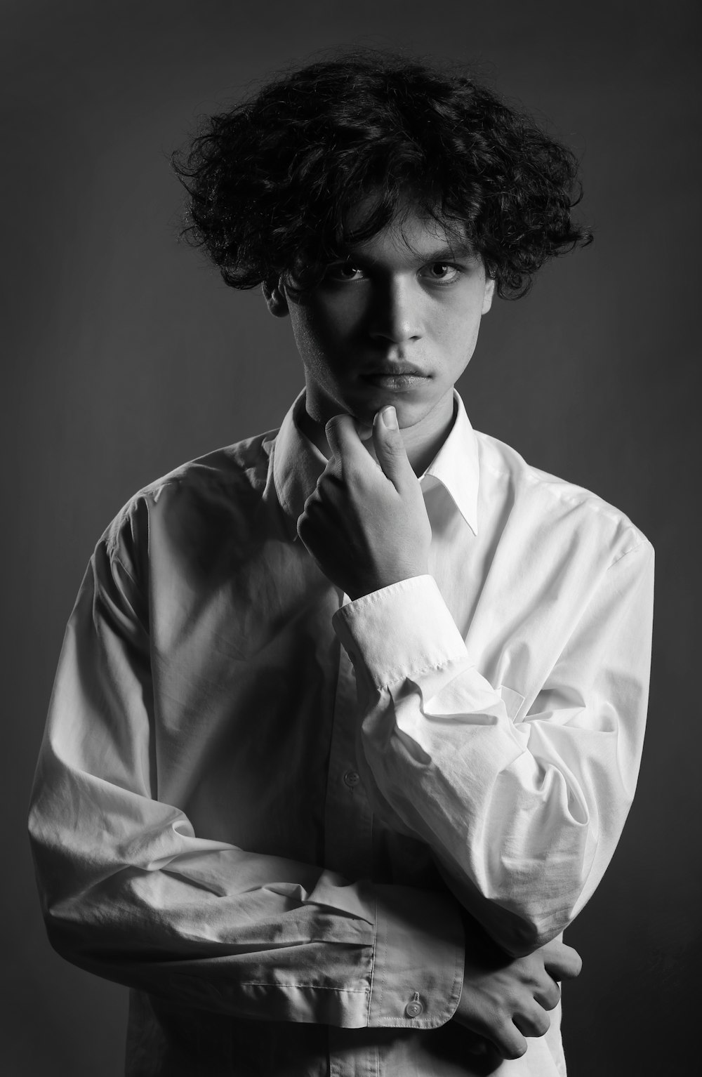 a black and white photo of a man with curly hair