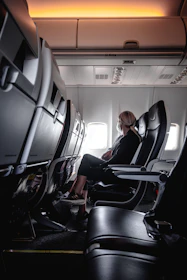 a woman sitting in a seat on an airplane