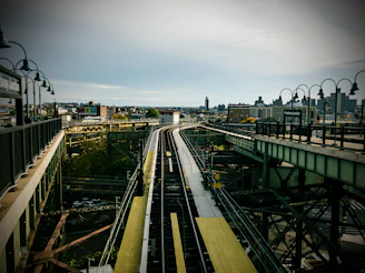 Engineers inspecting railway tracks with a backdrop of a bustling city skyline.