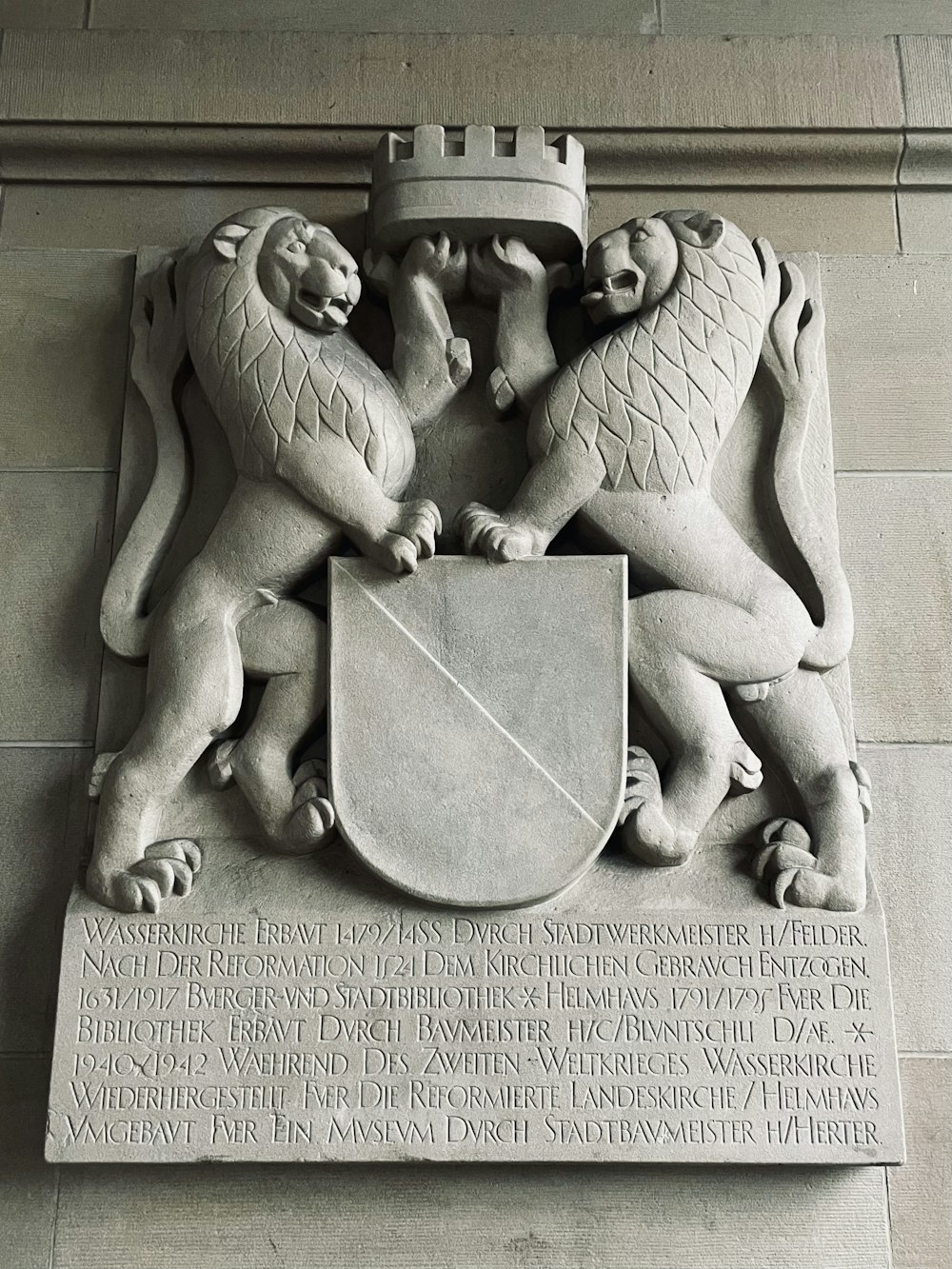 a statue of two lions holding a shield