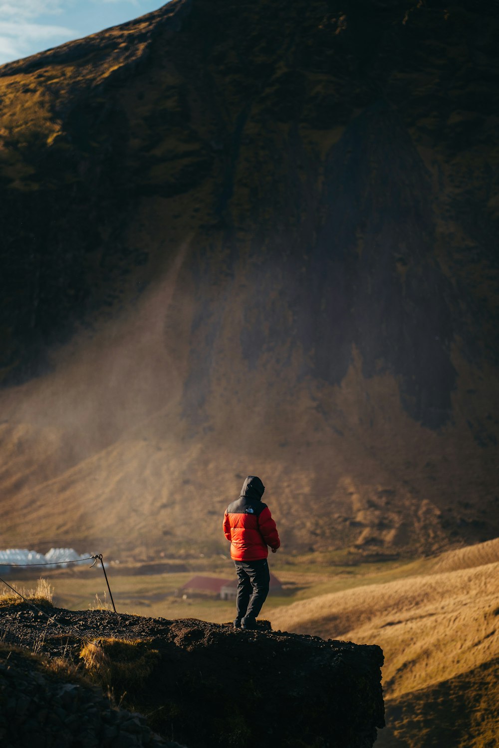 a man standing on top of a rocky hill