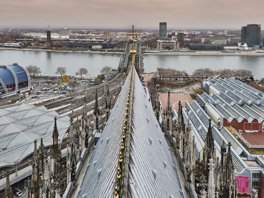 an aerial view of a train station with a bridge in the background