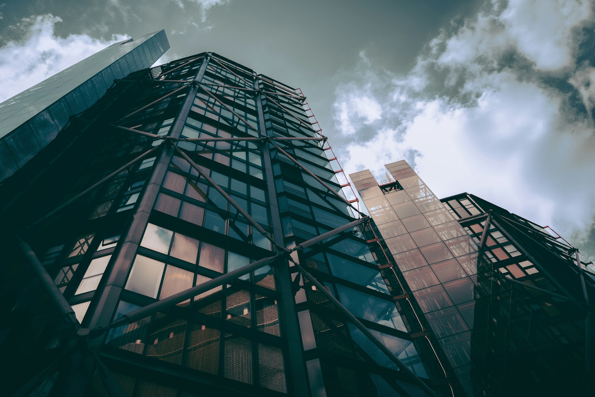 a tall building with lots of windows under a cloudy sky