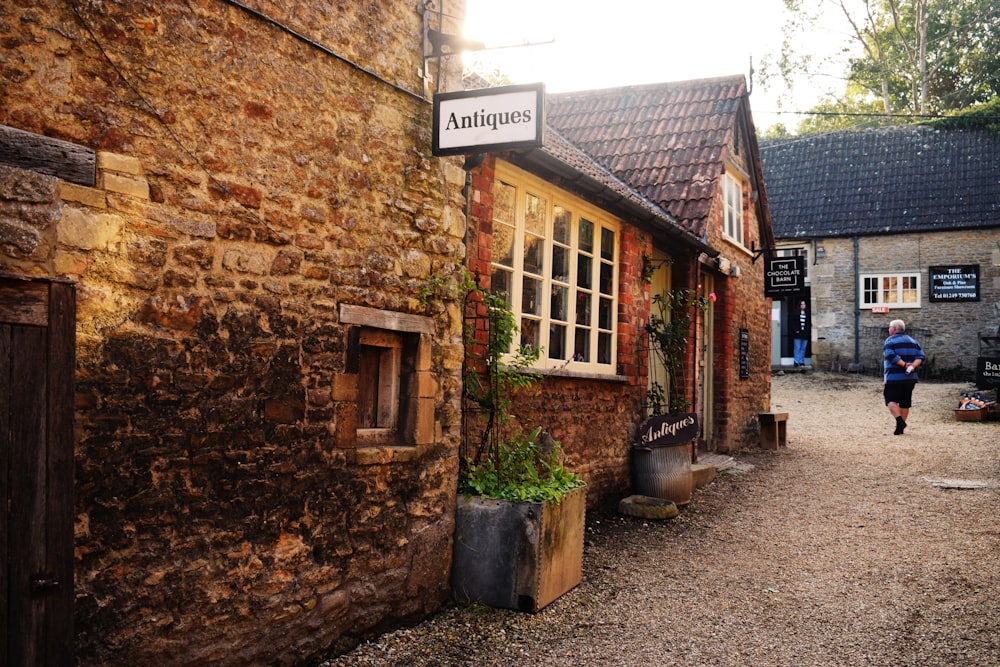 a brick building with a sign that says antiques