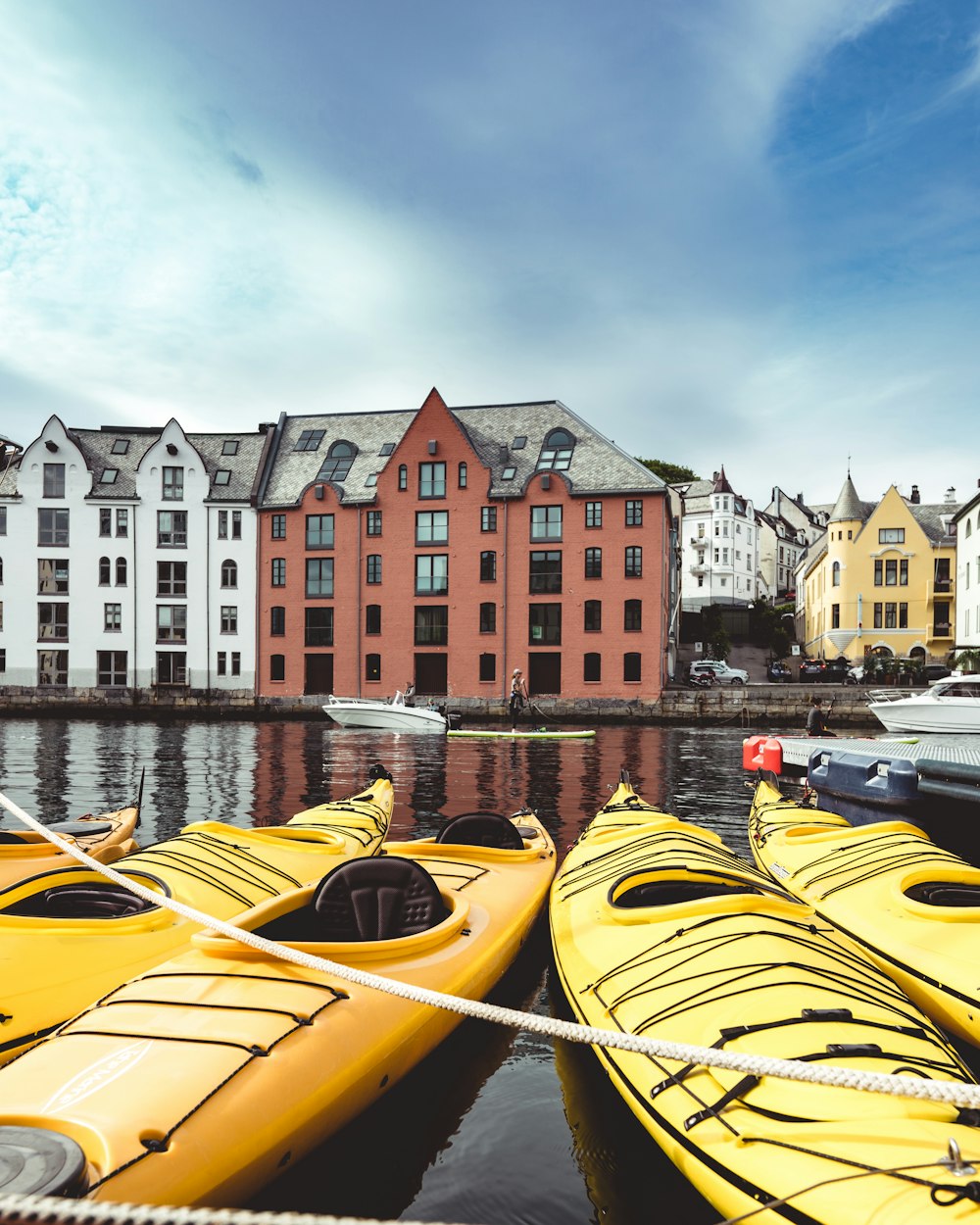 a group of yellow kayaks tied to a dock