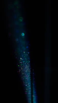 Abstract dark background with scattered illuminated letters floating gently.