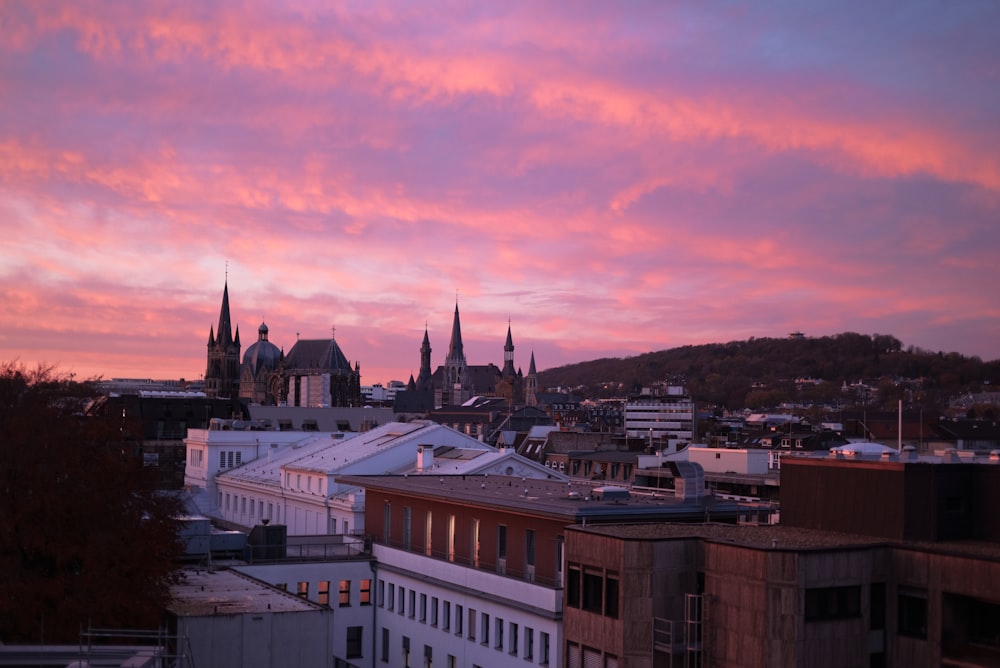 a view of a city at sunset with a pink sky