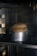 A close-up of fresh bread rising in a warm kitchen environment.