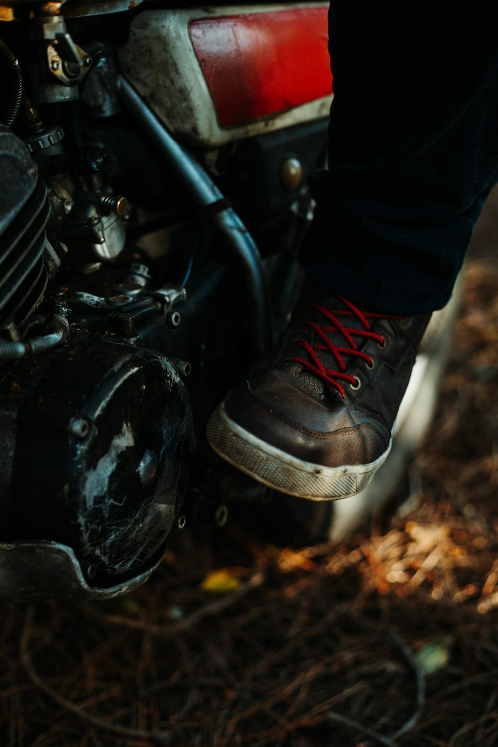 a close up of a person's feet on a motorcycle