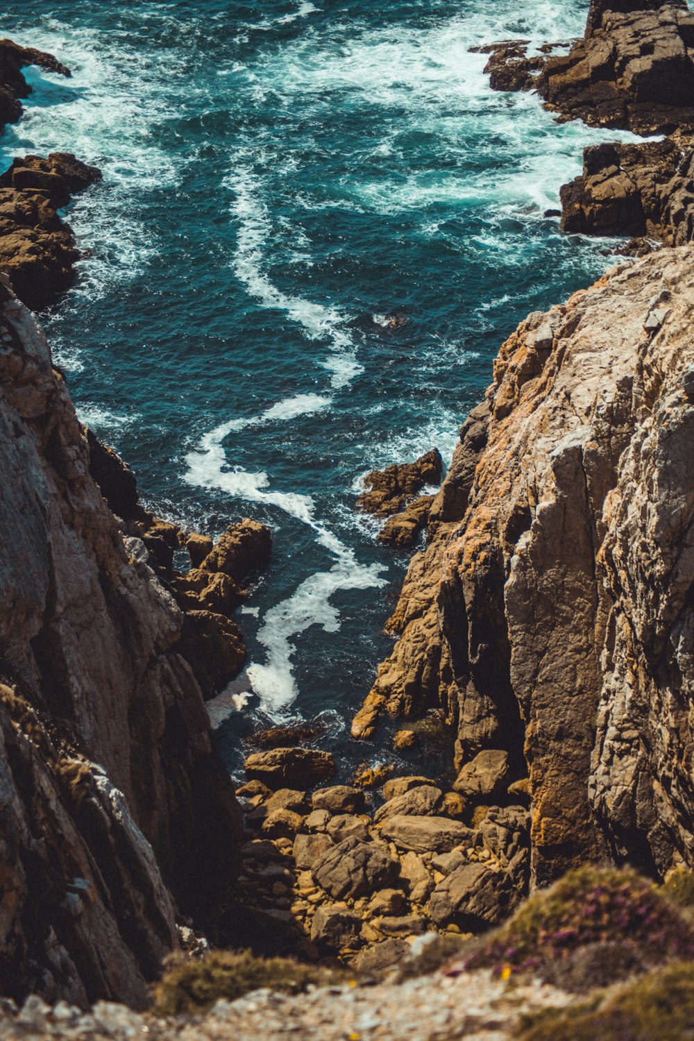 a view of the ocean from a rocky cliff