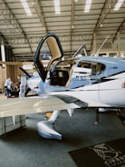 a small airplane sitting inside of a hangar