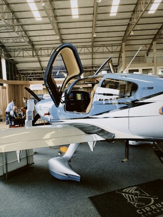 a small airplane sitting inside of a hangar
