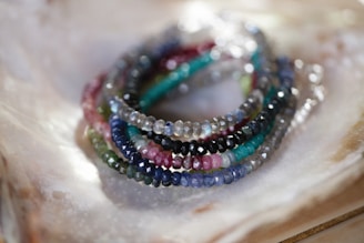 a group of bracelets sitting on top of a shell