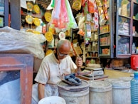 A small business owner arranging products in a cozy shop.