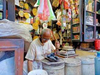 A close-up of a local shopkeeper arranging products in their store.
