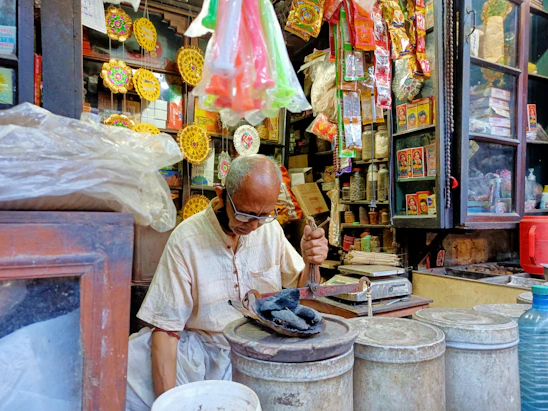 Small business owner smiling while organizing products in a local shop.
