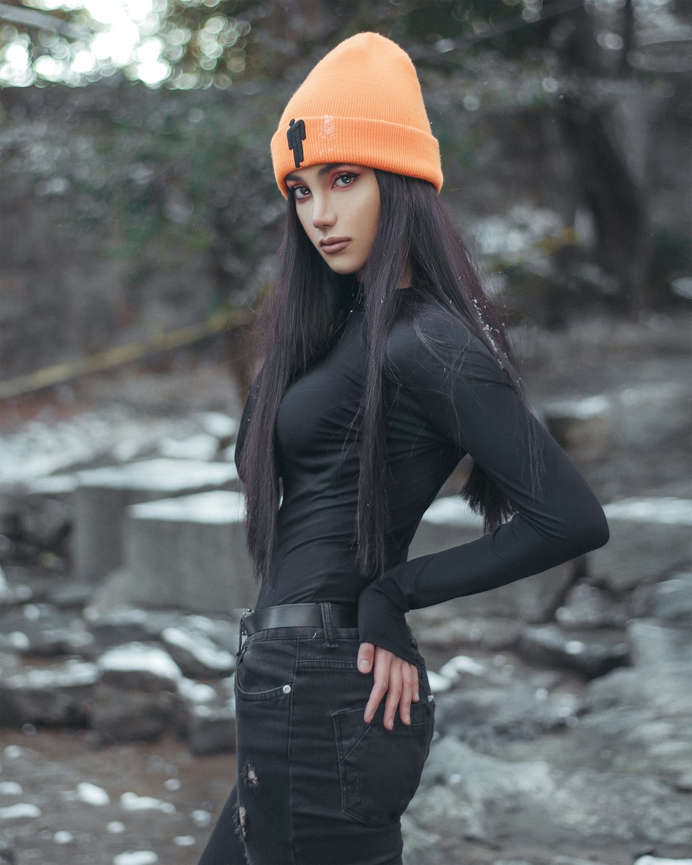 a woman in a black top and orange hat