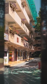 a building with a lot of windows and flowers on the balconies