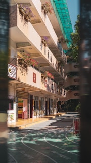 a building with a lot of windows and flowers on the balconies