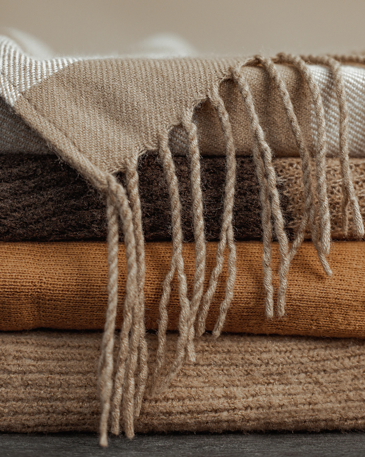 Folded bed blankets and throws prepared for seasonal storage