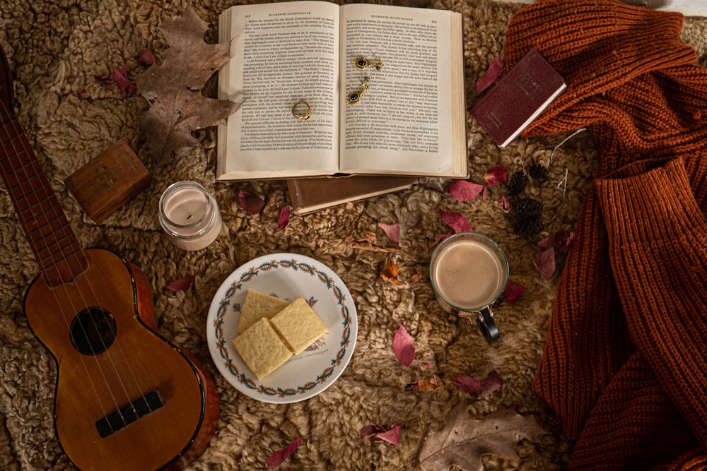 a table topped with an open book next to a plate of food