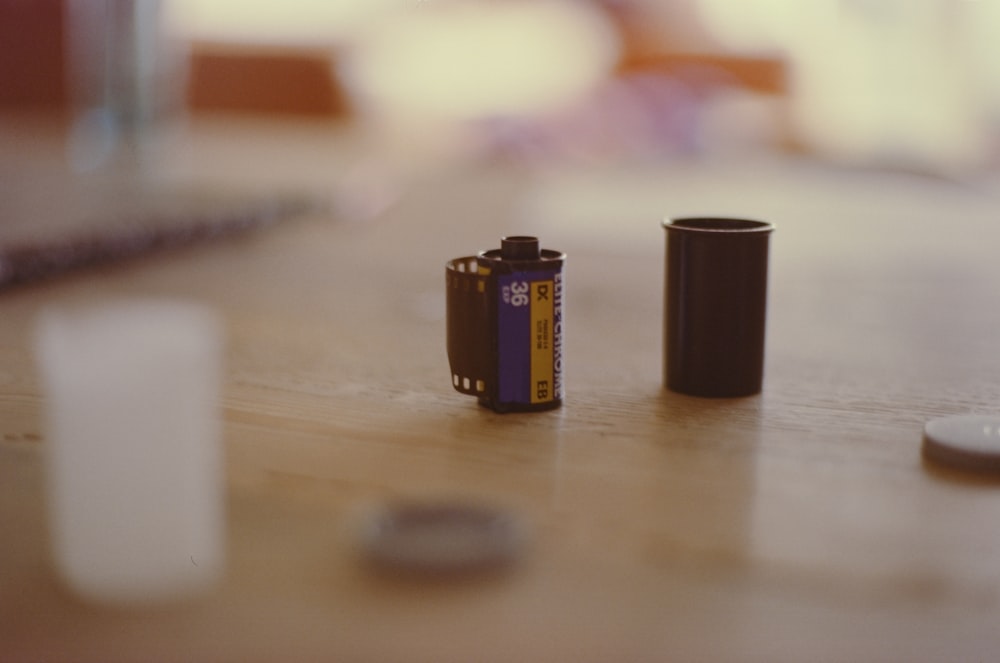 a couple of batteries sitting on top of a wooden table