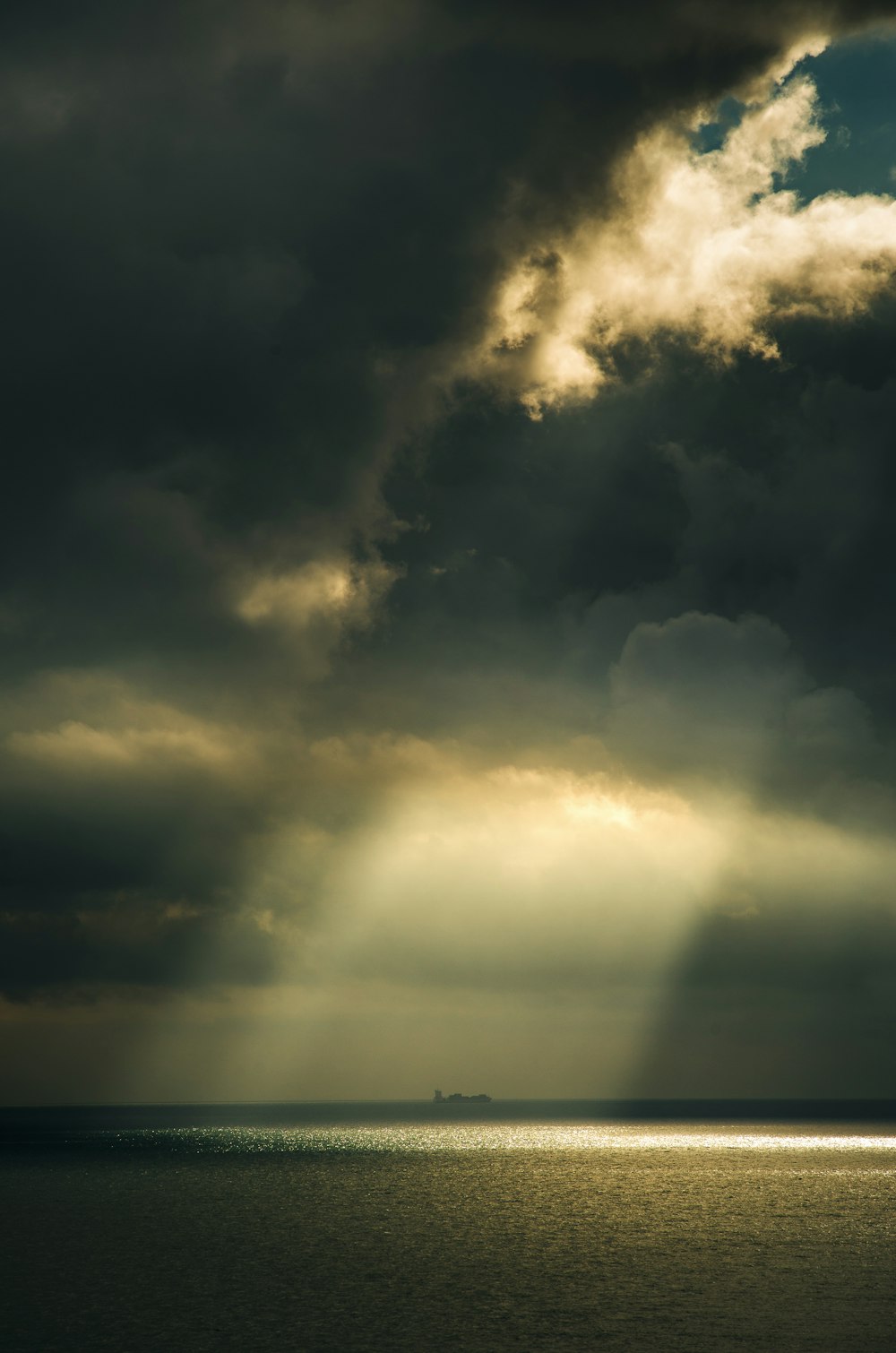 a large body of water under a cloudy sky