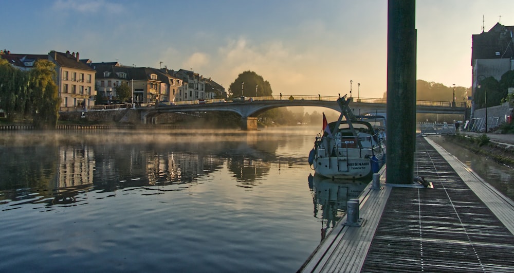 a body of water with a bridge in the background