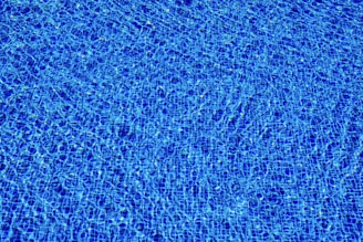 a blue swimming pool with ripples of water