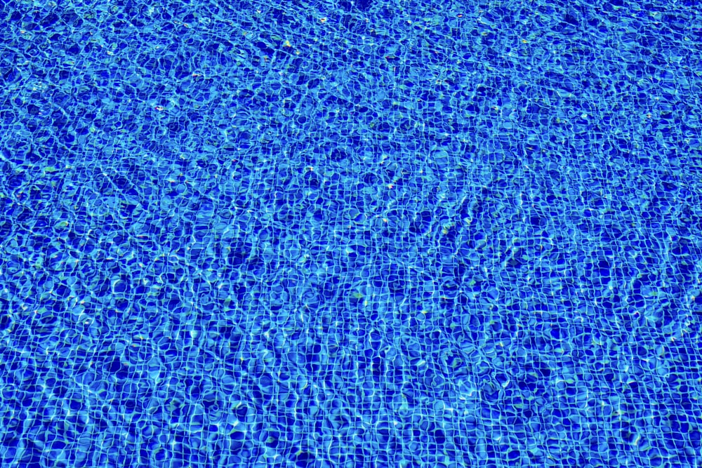 a blue swimming pool with ripples of water