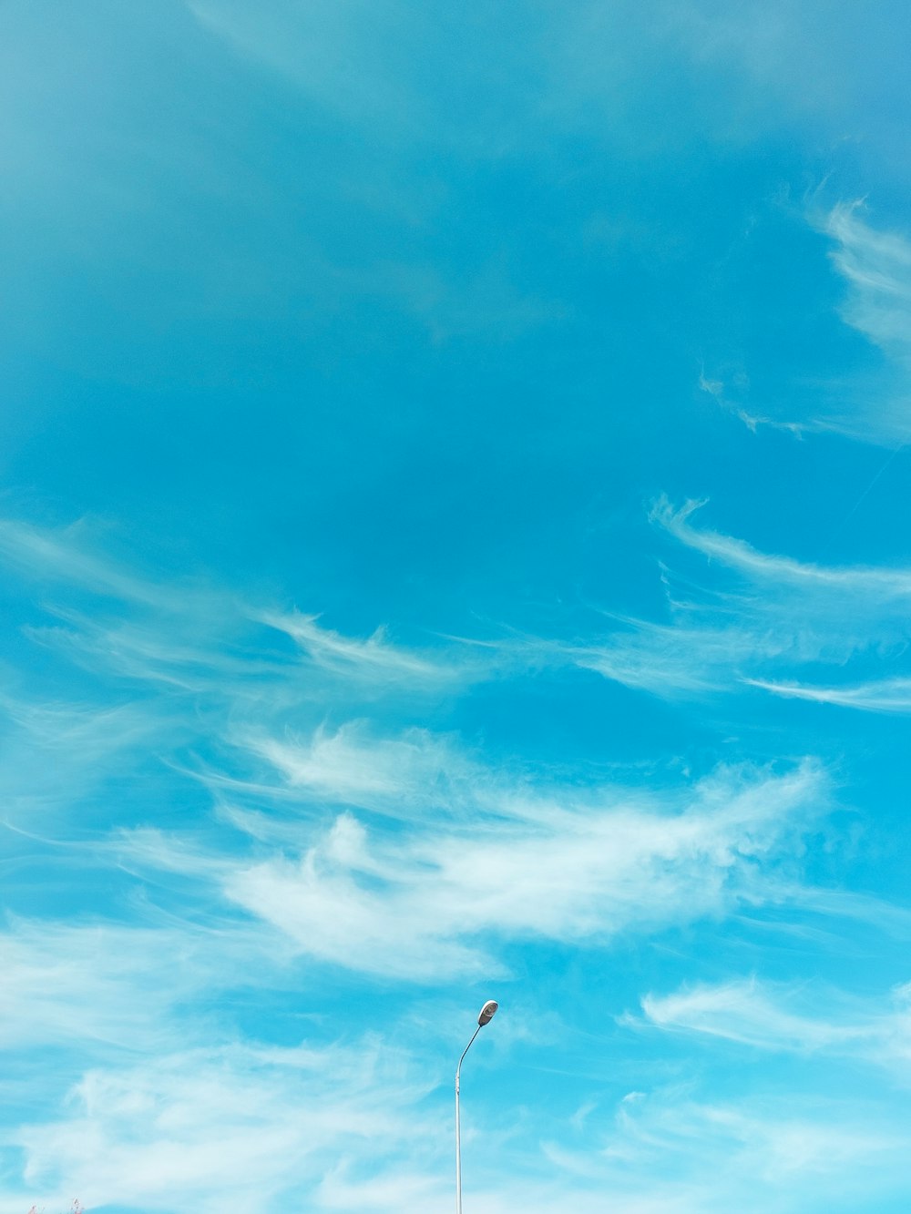 a person flying a kite in a blue sky