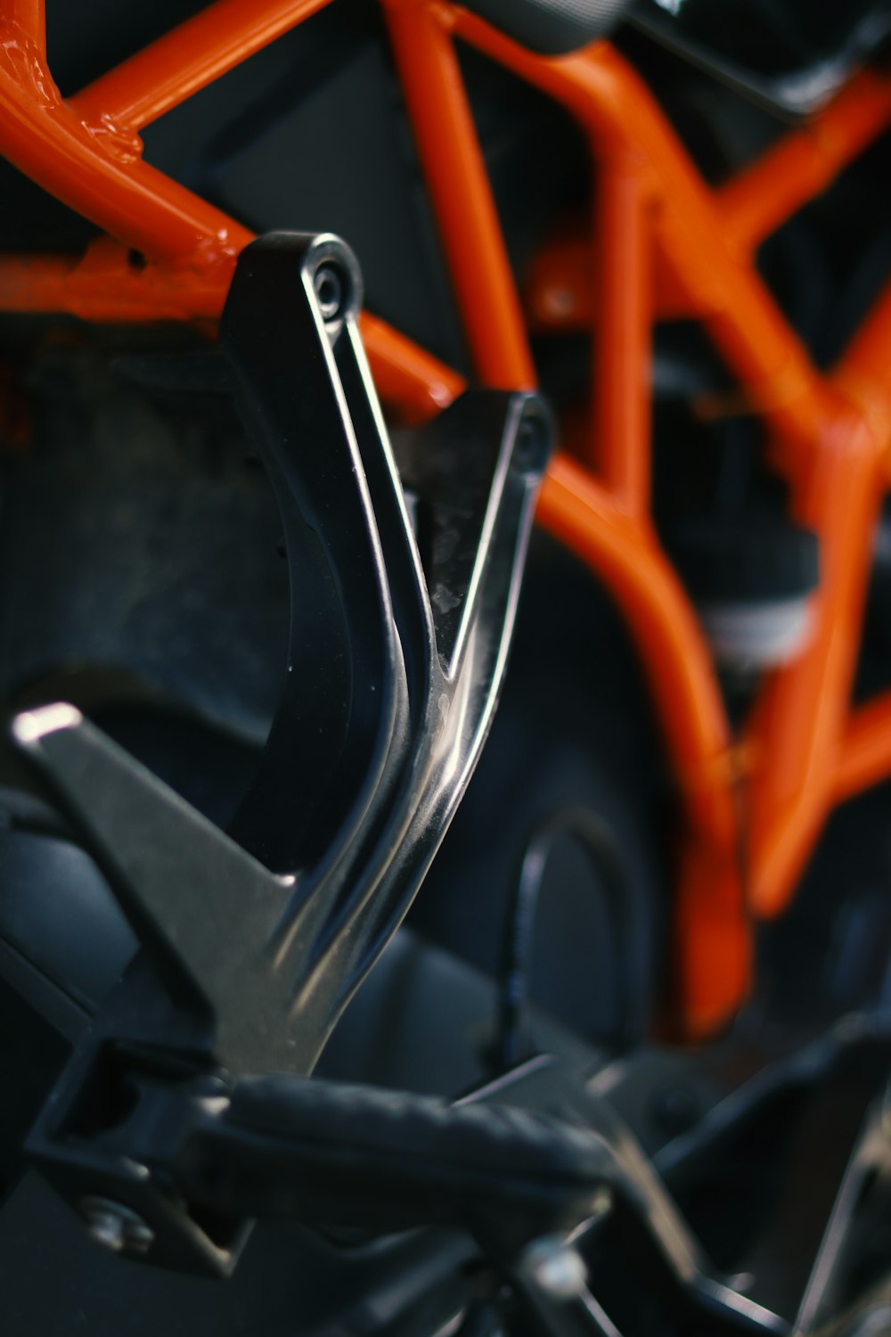 a close up of an orange and black bike frame