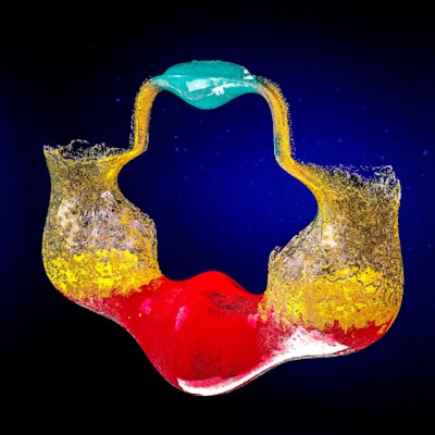 A vibrant teal background with abstract shapes representing creativity.