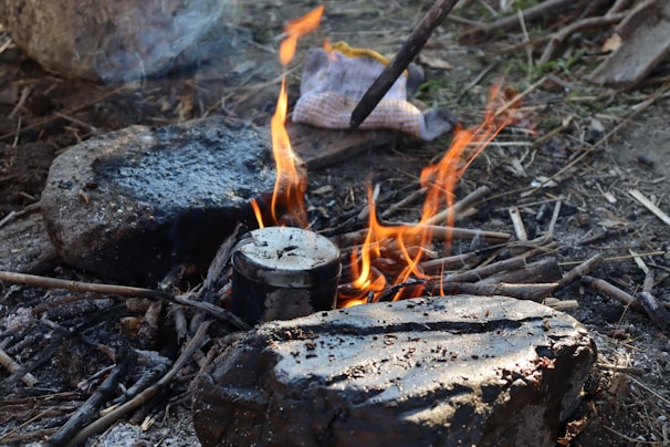 A makeshift outdoor kitchen with improvised utensils and fresh ingredients.