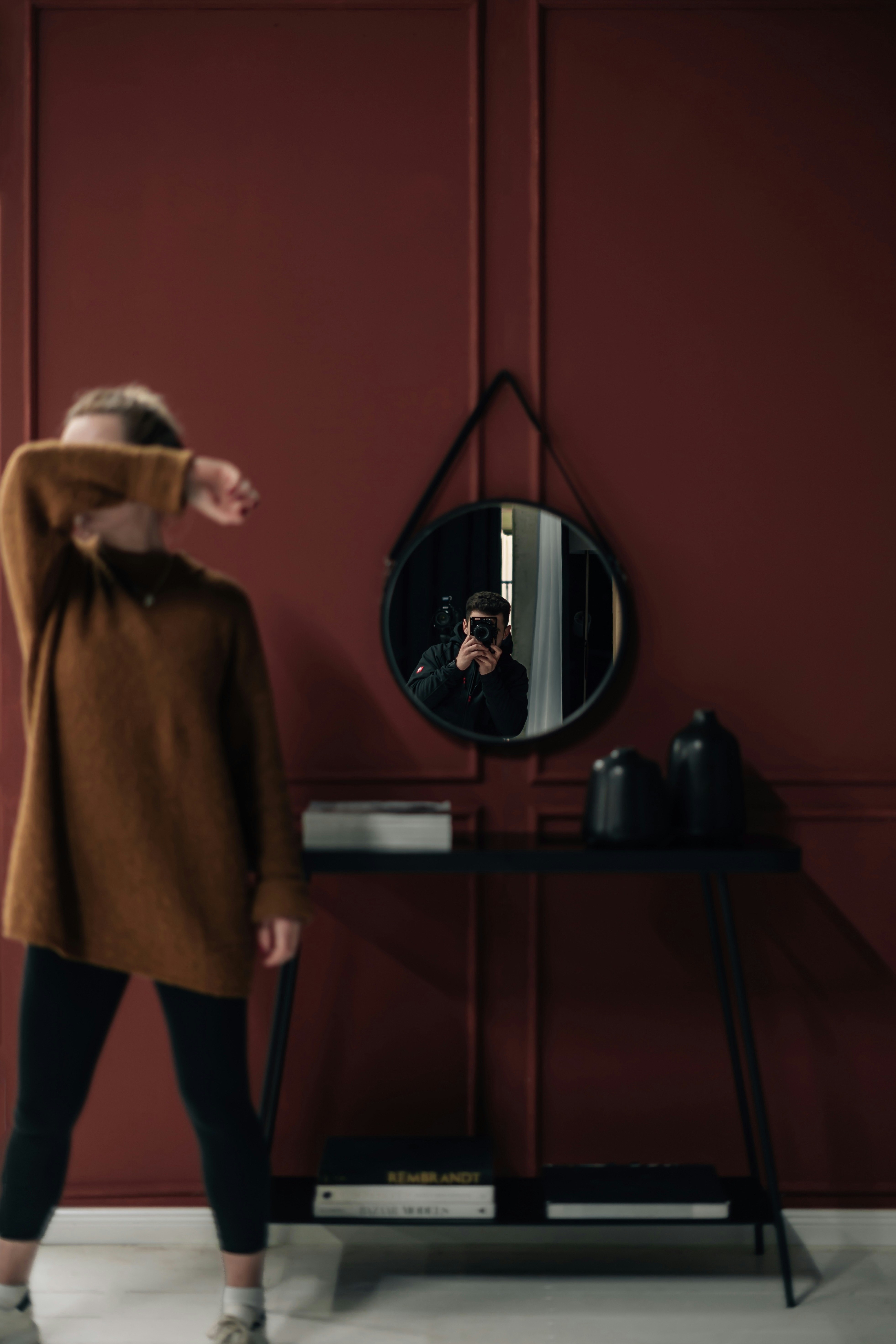a woman taking a picture of herself in a mirror
