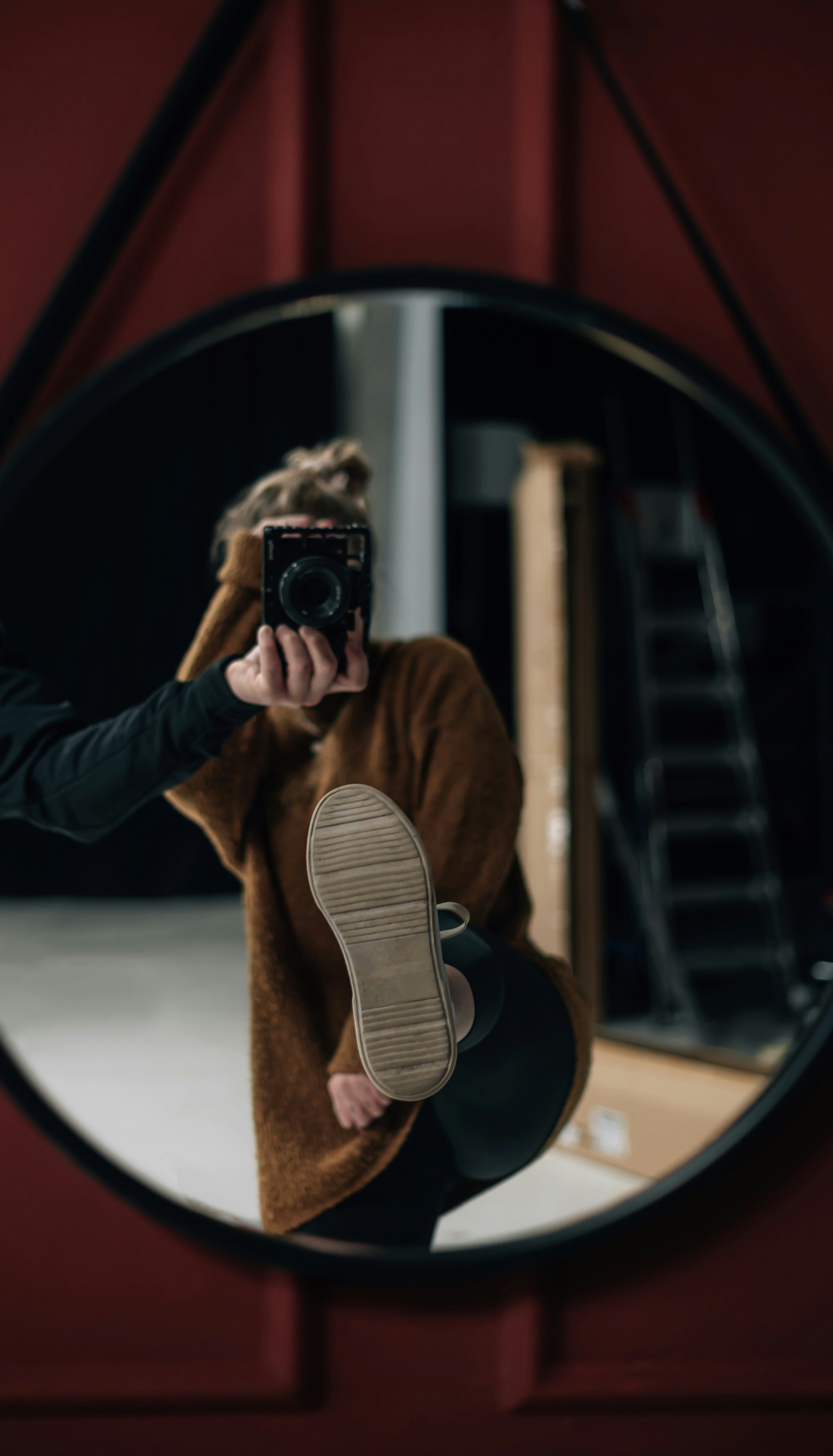 a woman taking a picture of herself in a mirror