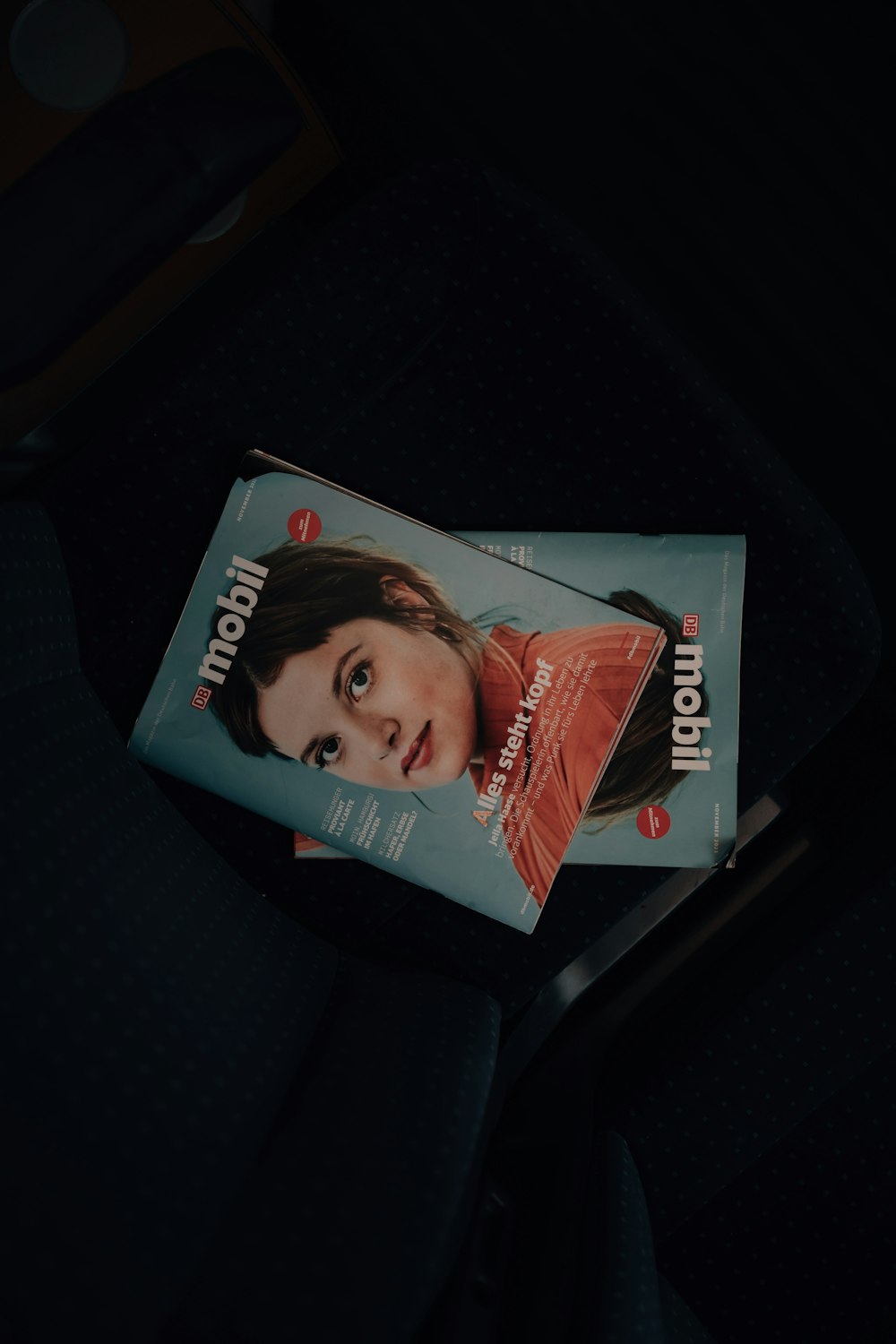 a magazine sitting on top of a seat in a car