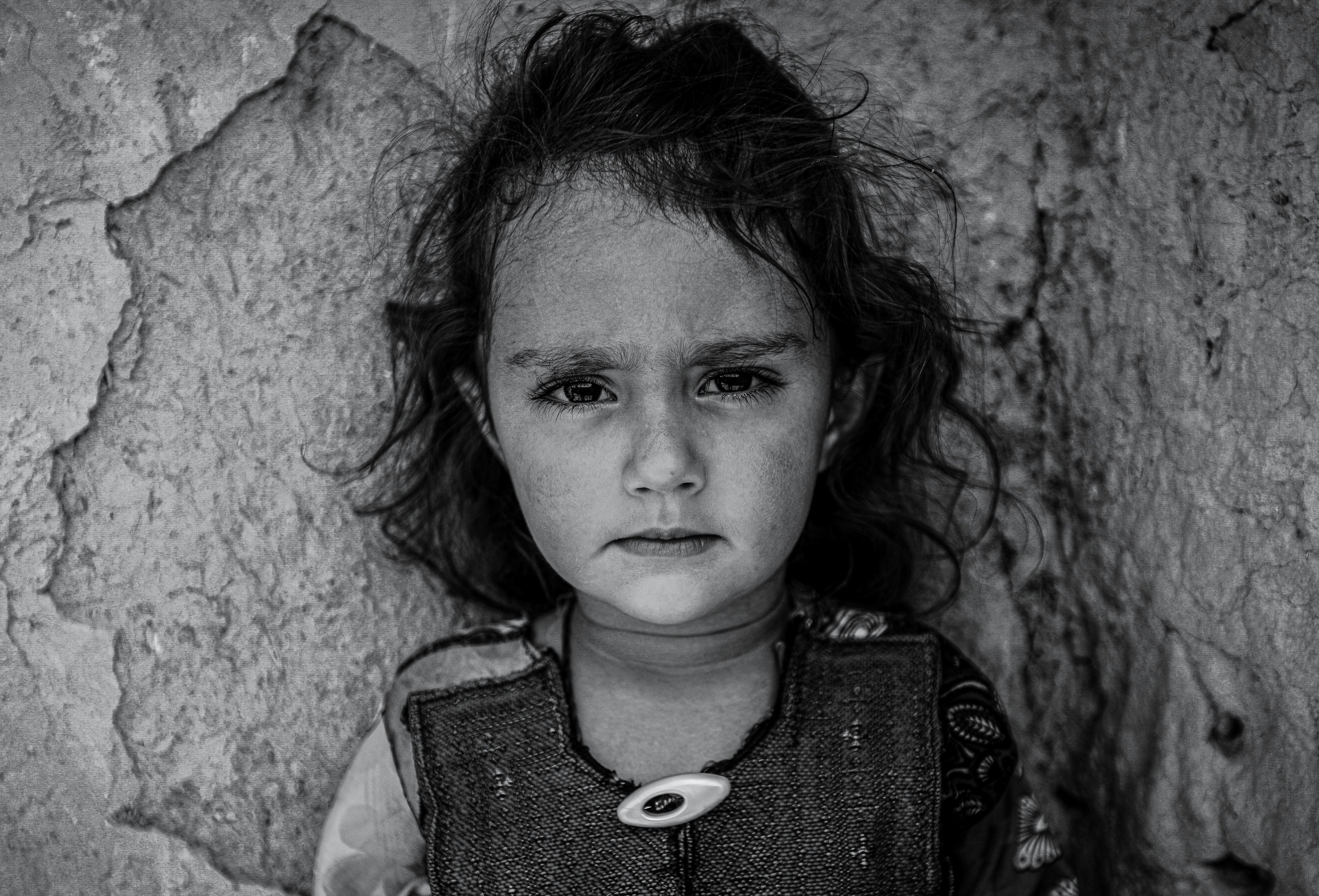 a black and white photo of a little girl